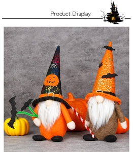 Close-up of Halloween gnomes with spiderweb hats and pumpkins on a festive background