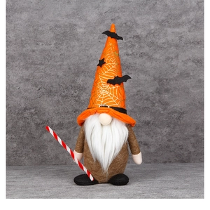 Macro detail of plush Halloween gnome with orange spider web hat and white beard decoration