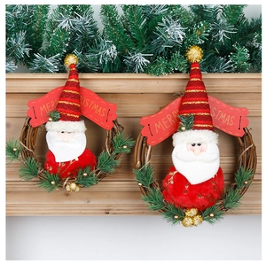 Close-up of rustic rattan Christmas wreath with Santa Claus doll and Merry Christmas banner