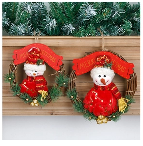 Detail view of woven rattan Christmas wreaths with plush snowmen and Merry Christmas banners