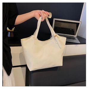 Detail of cream white tote bag with long shoulder straps and gold adjustment buckles