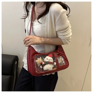 Detail of red leather tote bag with transparent display window and bow accent