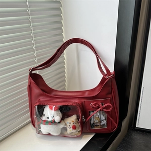 Red faux leather half-moon shoulder bag with transparent pocket and plush dog toy