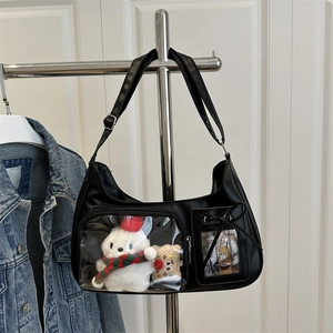 Minimalist black ita bag with transparent window featuring plush bear and card holder