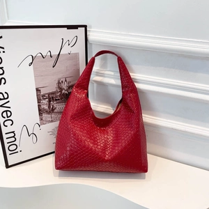 Fashion red woven leather tote handbag with integrated shoulder strap on minimalist white base