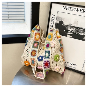 Close-up of bohemian crochet tote bag featuring vibrant 3D floral knit patterns and texture
