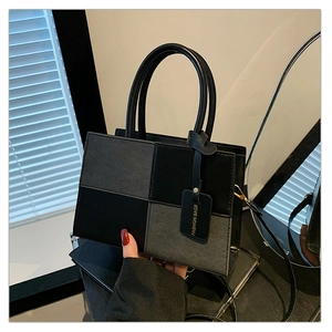 Detail of color-block checkerboard handbag with smooth leather and matte texture finish