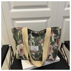 Close-up of floral jacquard fabric and thick straps on a large canvas tote bag