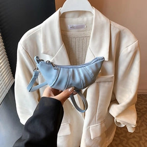 Minimalist light blue pleated croissant crossbody bag with a slim strap and metal zipper