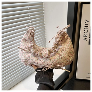 Detailed close-up of floral cloud bag showing ruched edges and delicate ribbon bows