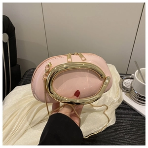 Macro view of high-gloss light pink patent leather texture and gold C-handle detail