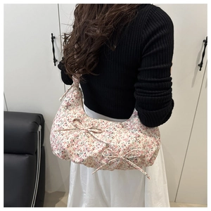 Floral hobo bag detail with pink bow accents and dense canvas texture for women