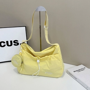 Bright yellow nylon tote bag with drawstring design and mini round coin purse