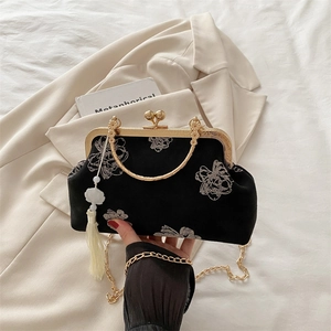 Vintage black fabric shell bag with white floral embroidery and gold metal frame