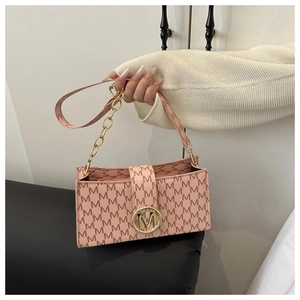 Detail of pink small square bag with M-letter monogram print and golden metal clasp