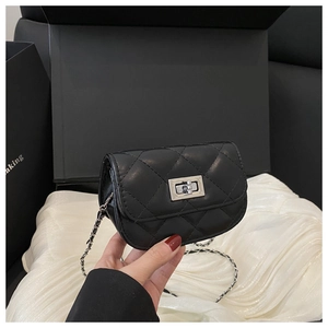 Detail of black quilted mini chain bag featuring a silver metal twist lock and chain strap