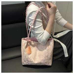 Detail of pink floral jacquard tote bag with butterfly embroidery and woven straps