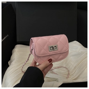 Detail of pink quilted leather mini crossbody bag with silver twist lock and chain strap