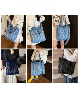 Detailed view of large denim tote bag featuring distressed GENTLE YOUTH lettering