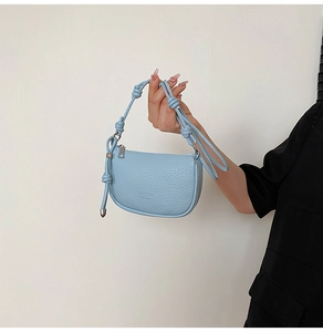 Detail der hellblauen Satteltasche aus Kieselleder mit Knotengriff und langem Reißverschluss