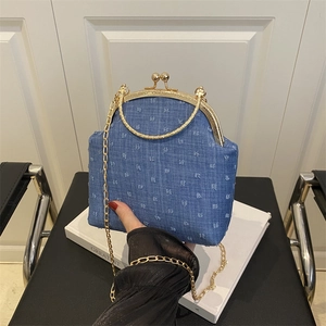 Blue denim crossbody bag with white dot pattern, gold metal handle and chain strap