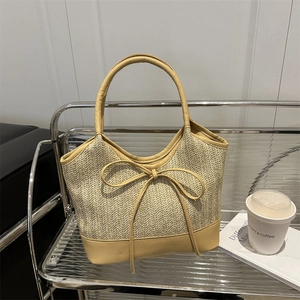 Straw woven shoulder bag with large yellow leather bow and chic summer vacation style