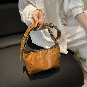 Brown faux leather crescent bag with adjustable grommet strap for casual styling