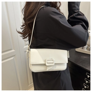 Detailed macro view of the creamy white lychee grain texture and minimalist square buckle