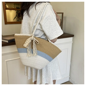 Detail of hand-woven tote bag with khaki blue white contrast and lace bow ornament