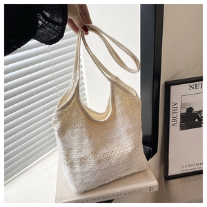 Detailed view of white floral lace crochet texture on a lightweight summer tote bag