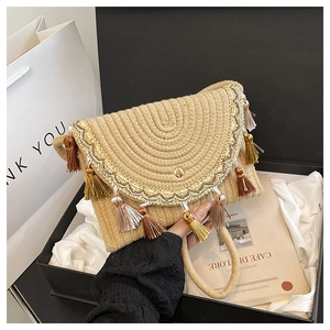 Bohemian woven straw bag with tassels and embroidery presented in a premium gift box