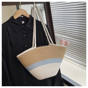 Detail of three-tone woven tote bag with chunky rope handles for beach and vacation
