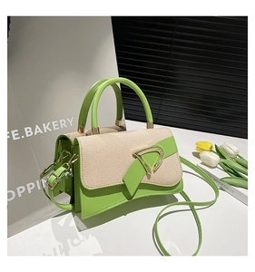 Detail of contrast stitch handbag with gold D buckle on a decorative tulip background