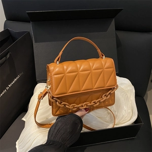 Orange quilted square handbag with chain and leather strap in a premium gift box