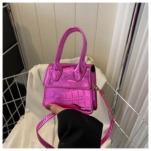 Close-up of fuchsia metallic stone pattern handbag with handle and shoulder strap