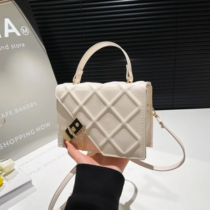 Chic quilted cream crossbody bag with gold chain strap and elegant top handle for women