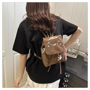 Brown faux leather mini backpack featuring a cute white cat face print on the front flap