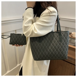 Détail du grand sac cabas noir matelassé avec surpiqûres blanches et petite pochette