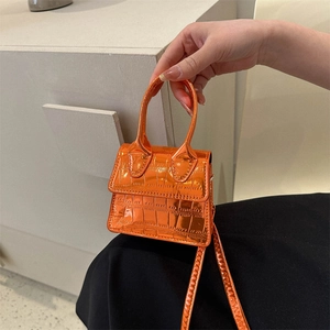 Metallic orange mini handbag with crocodile pattern and delicate shoulder strap