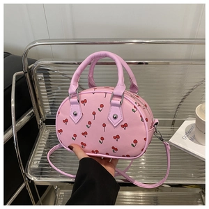 Detail of pink cherry print bowling bag with silver hardware on a metallic stand