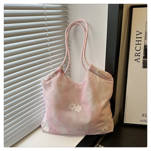 Detailed close-up of pink tie-dye tote bag featuring delicate white floral embroidery