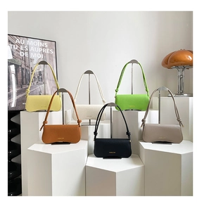 Collection of minimalist leather shoulder bags in six colors on geometric stands