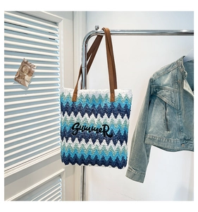 Detail of colorful chevron woven tote bag with Summer embroidery and leather straps