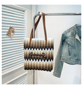 Detail of bohemian woven tote bag featuring wavy stripes and Summer embroidery