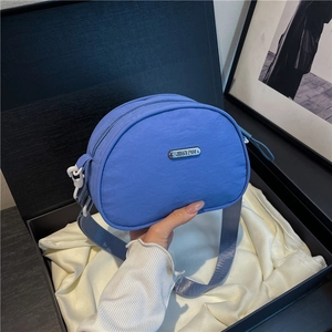 Blue nylon crossbody shoulder bag for women with rectangular metal logo and wide strap