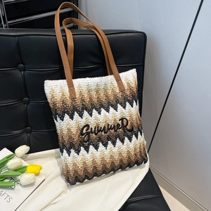 Handwoven summer tote bag with zigzag stripes and Summer embroidery on black chair