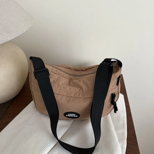 Fashionable khaki crescent-shaped waist bag with adjustable black shoulder strap
