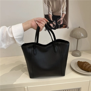 Minimalist black leather tote bag for women showing spacious design and elegant style