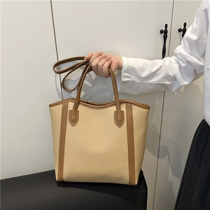 Minimalist beige and brown contrast tote bag with dual handles and long shoulder strap