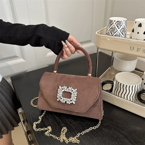 Brown suede crossbody bag with sparkling rhinestone buckle and gold chain strap